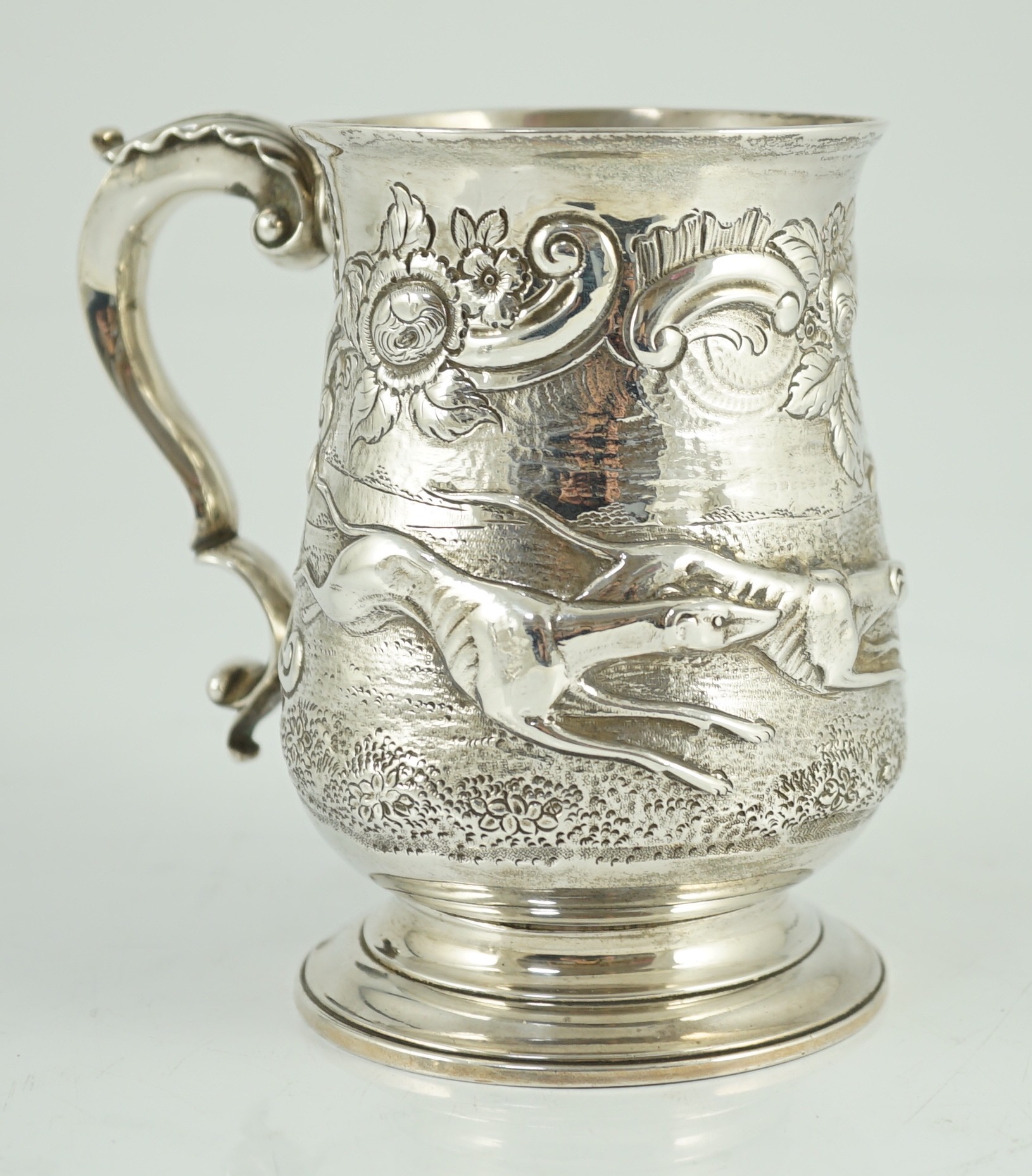 A George III silver baluster mug, later embossed with continuous hare coursing scene, John Scofield